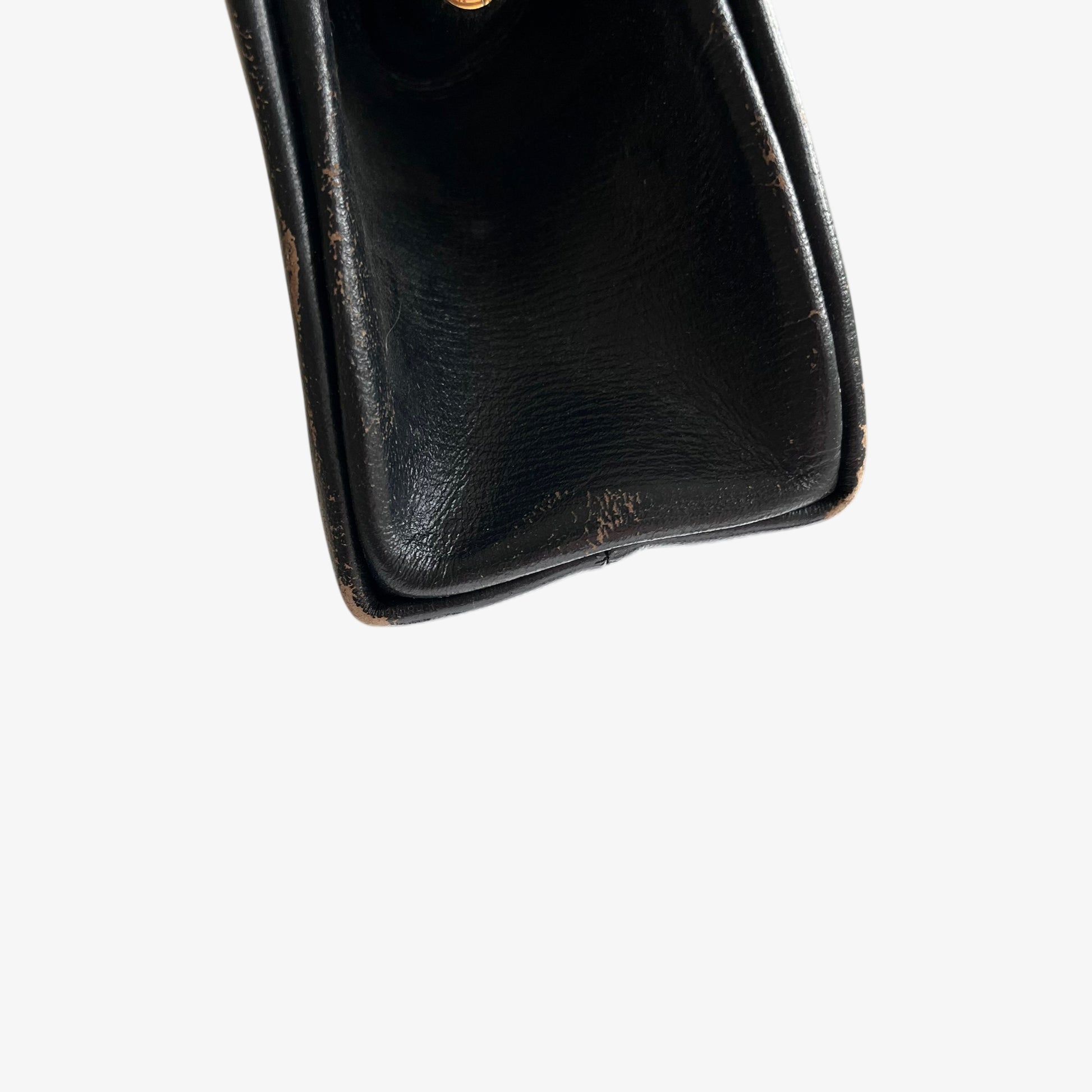 Close up of patina on a vintage 1950s black leather frame bag.