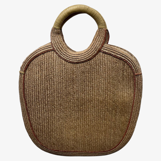 Back of a vintage 1950s crane and tree embroidered brown raffia tote bag on a white background.