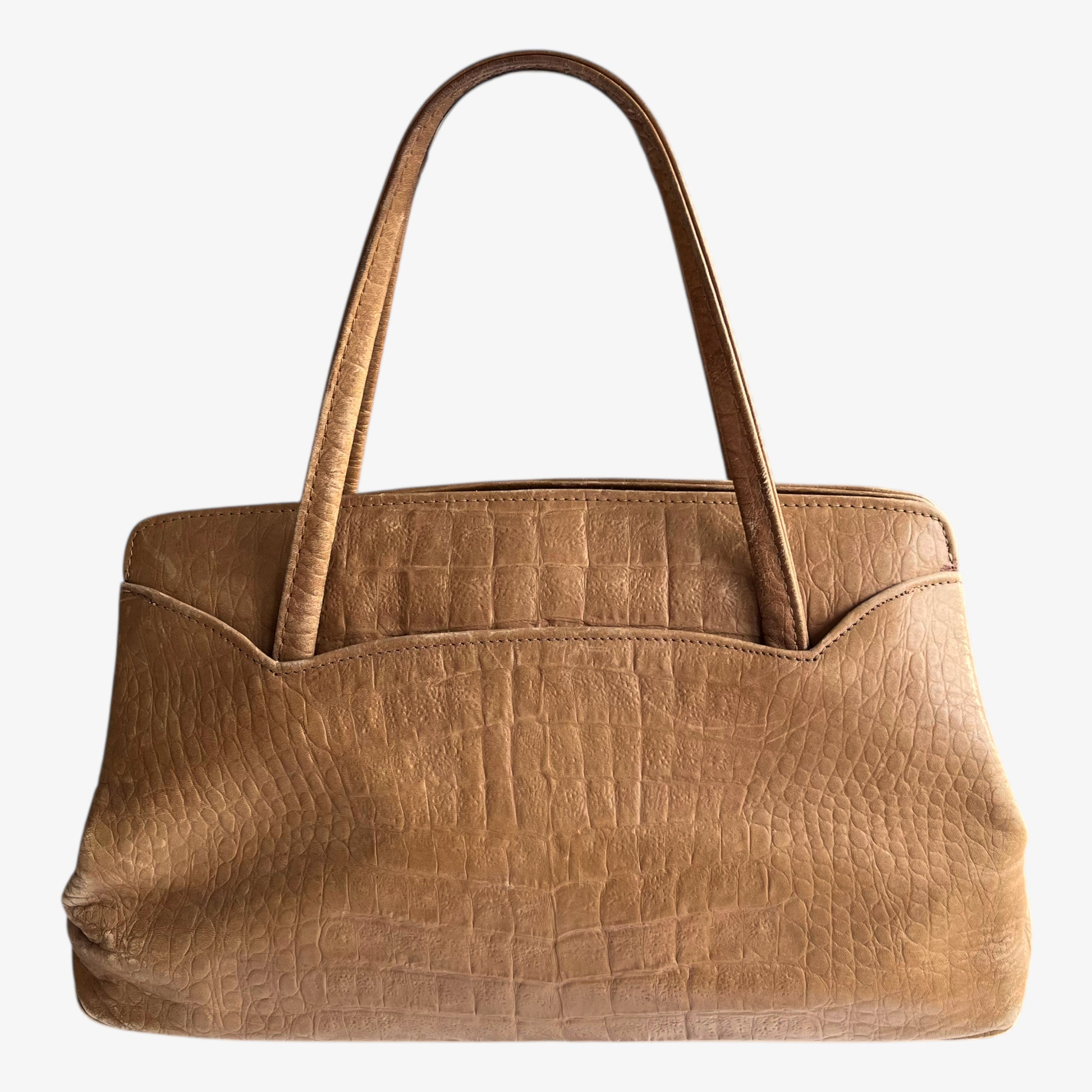Back of vintage 1950s crocodile embossed light brown leather shoulder bag on a white background.
