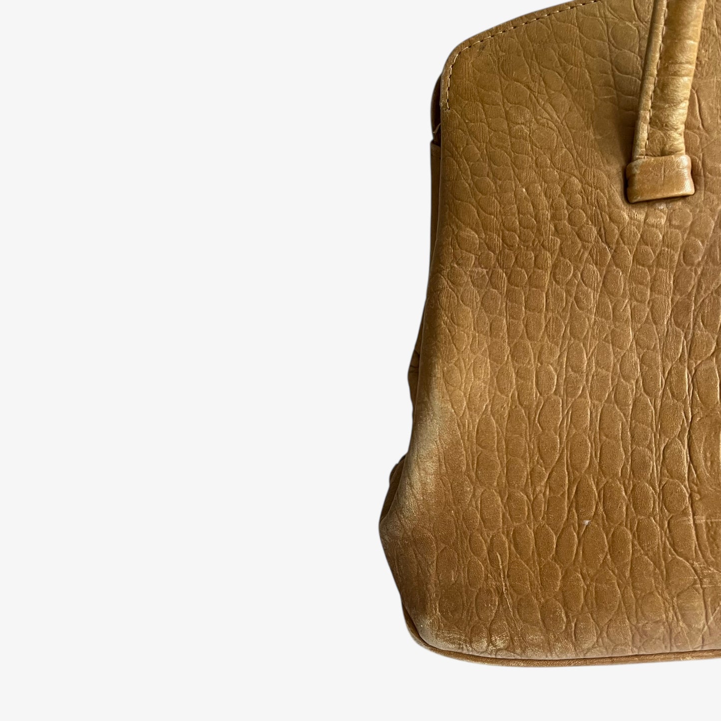 Faded crocodile embossed pattern on a vintage 1950s light brown leather shoulder bag.