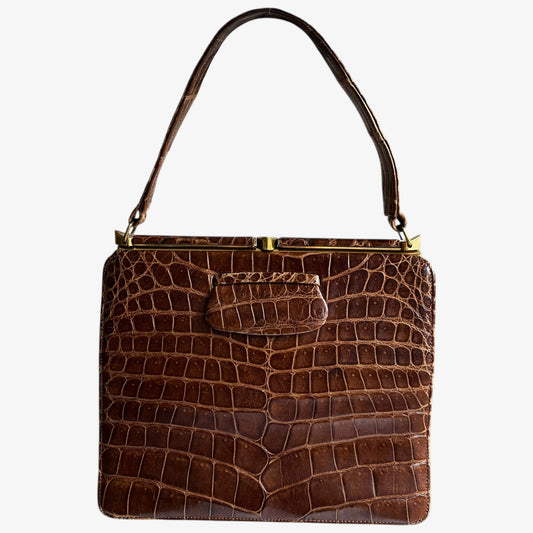 Vintage 1950s Riviera crocodile embossed brown leather shoulder bag on a white background.
