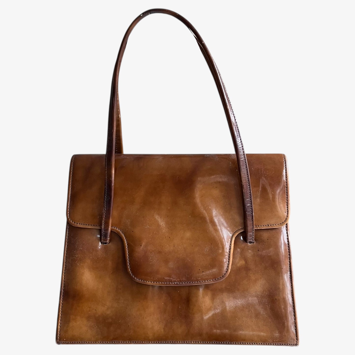 Vintage 1960s misty cognac brown faux leather flap on a white background.