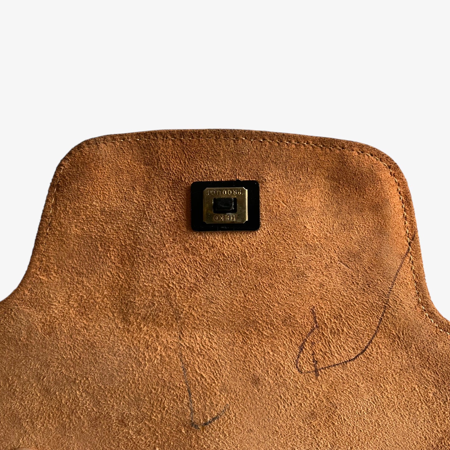 Heko label engraved on the clasp of a vintage 1960s misty cognac brown faux leather flap.