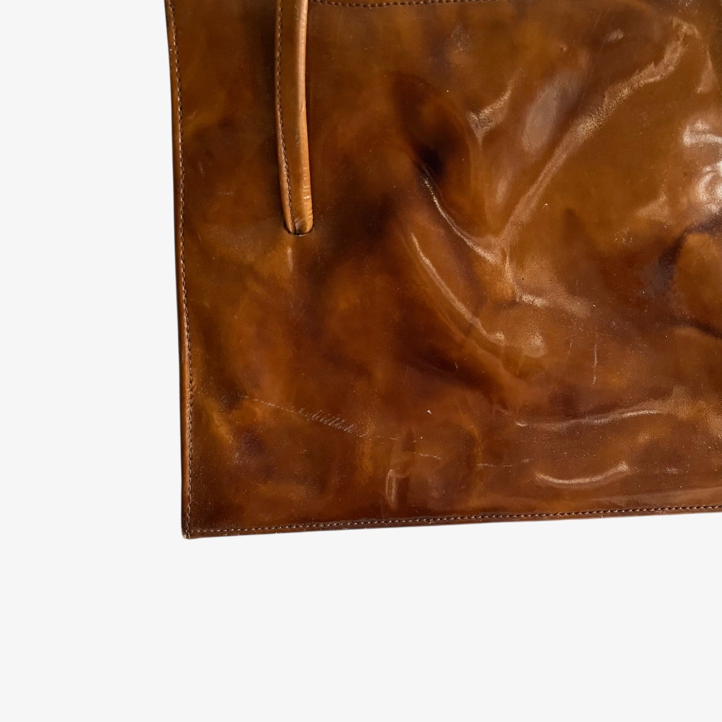 Close up in the patina on vintage 1960s misty cognac brown faux leather flap.