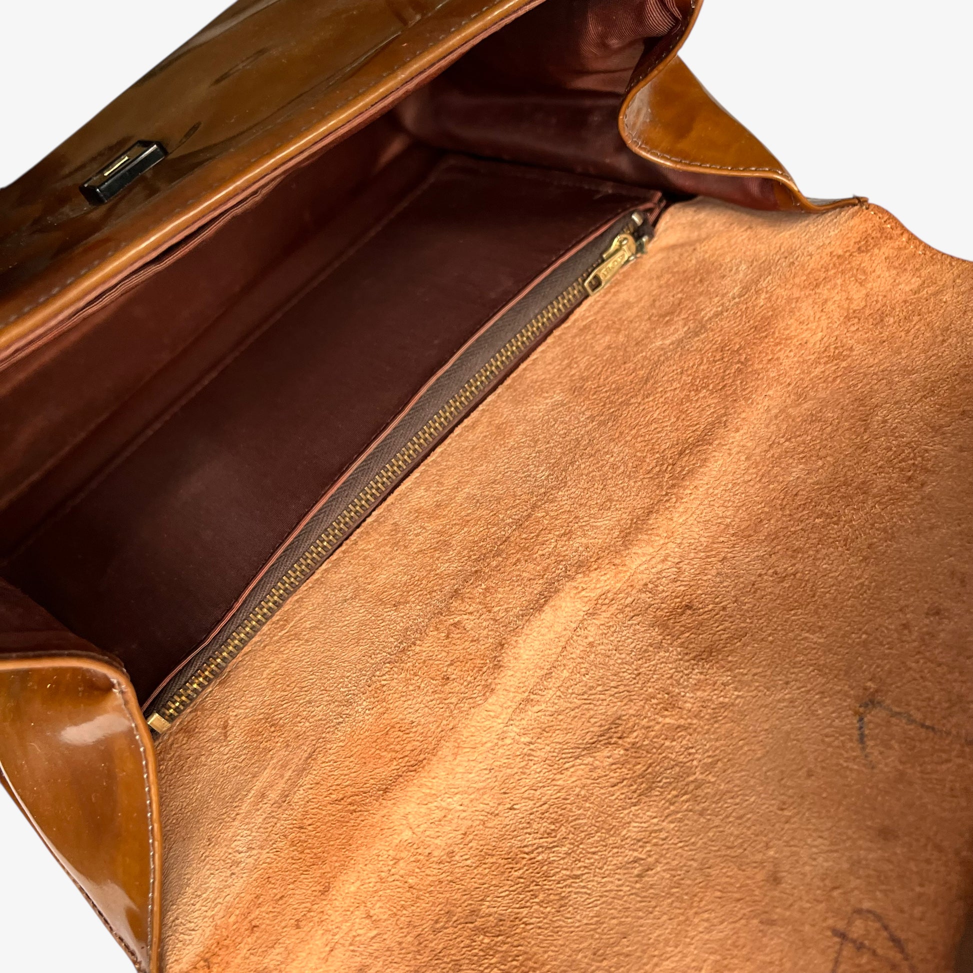 Inside of a vintage 1960s Heko misty cognac brown faux leather flap.