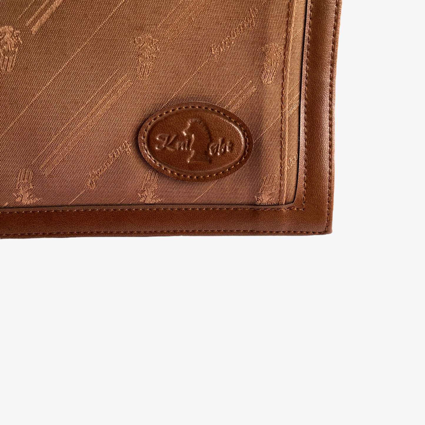 Close up of embroidered Knight leather brand tag on a vintage 1970s brown canvas crossbody messenger bag.