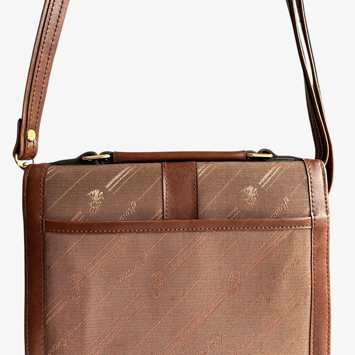 Close up of back pocket on a vintage 1970s brown canvas and leather crossbody messenger bag.