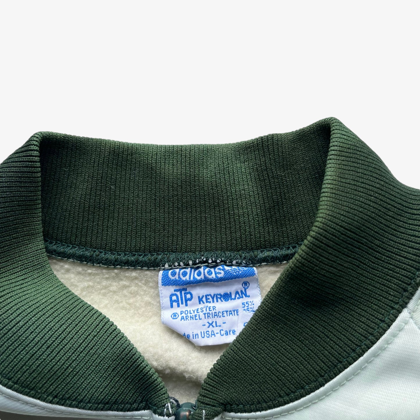 Adidas ATP Keyrolan label stitched inside of men's vintage 70s green track jacket.