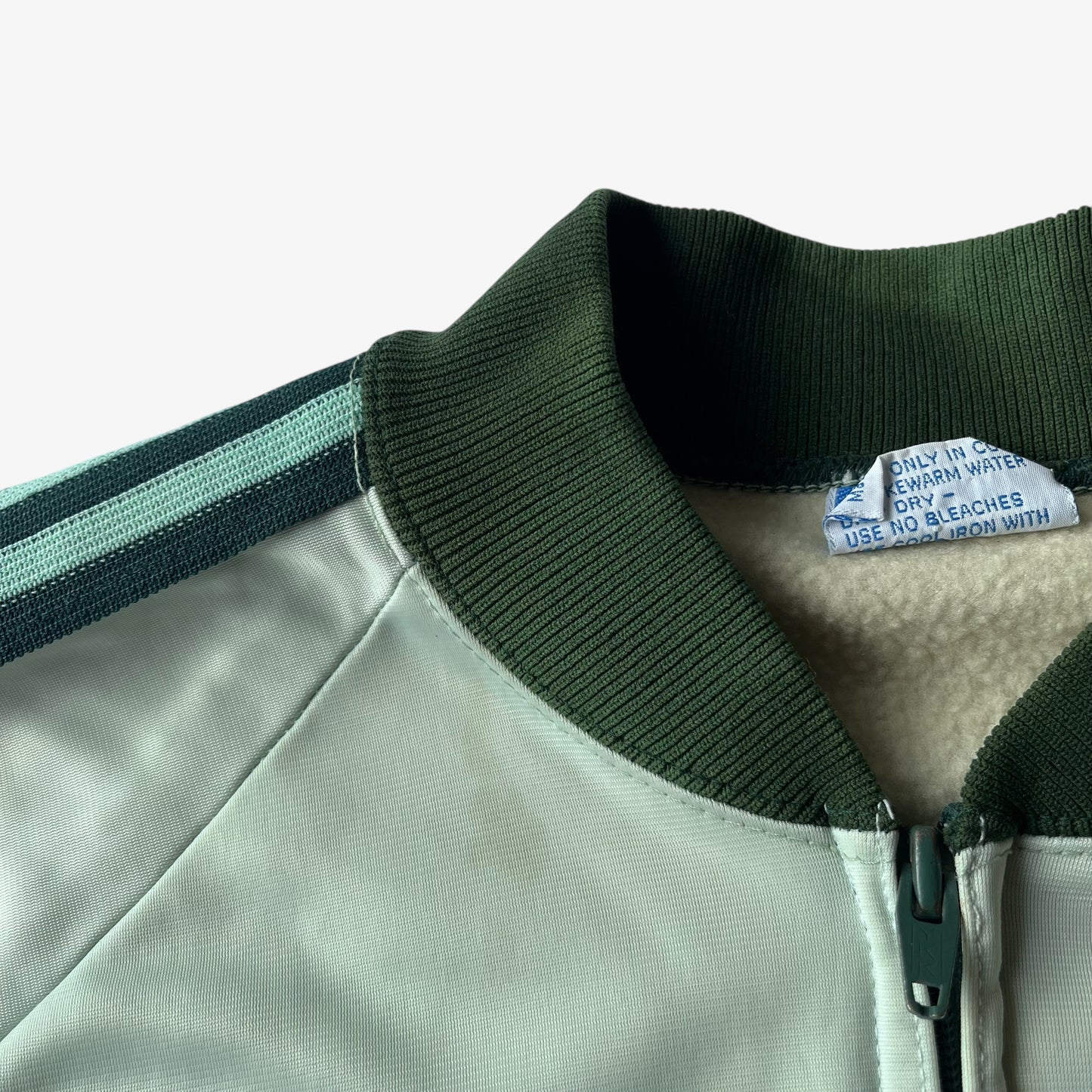 Ribbed collar of men's vintage 70s Adidas ATP Keyrolan green track jacket.