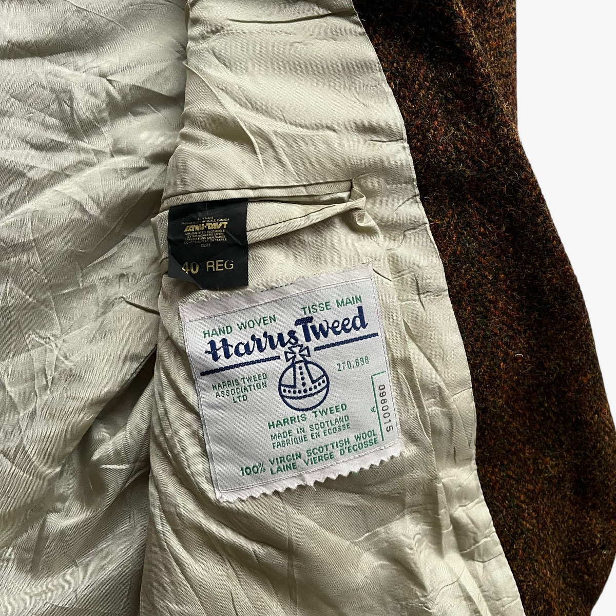 Harris Tweed stitched label of vintage 70s men's Moores pure virgin wool brown tartan print blazer.