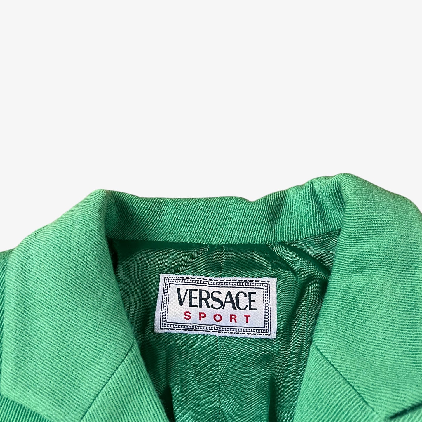 Label for vintage 70s Versace Sport women’s green wool blazer.