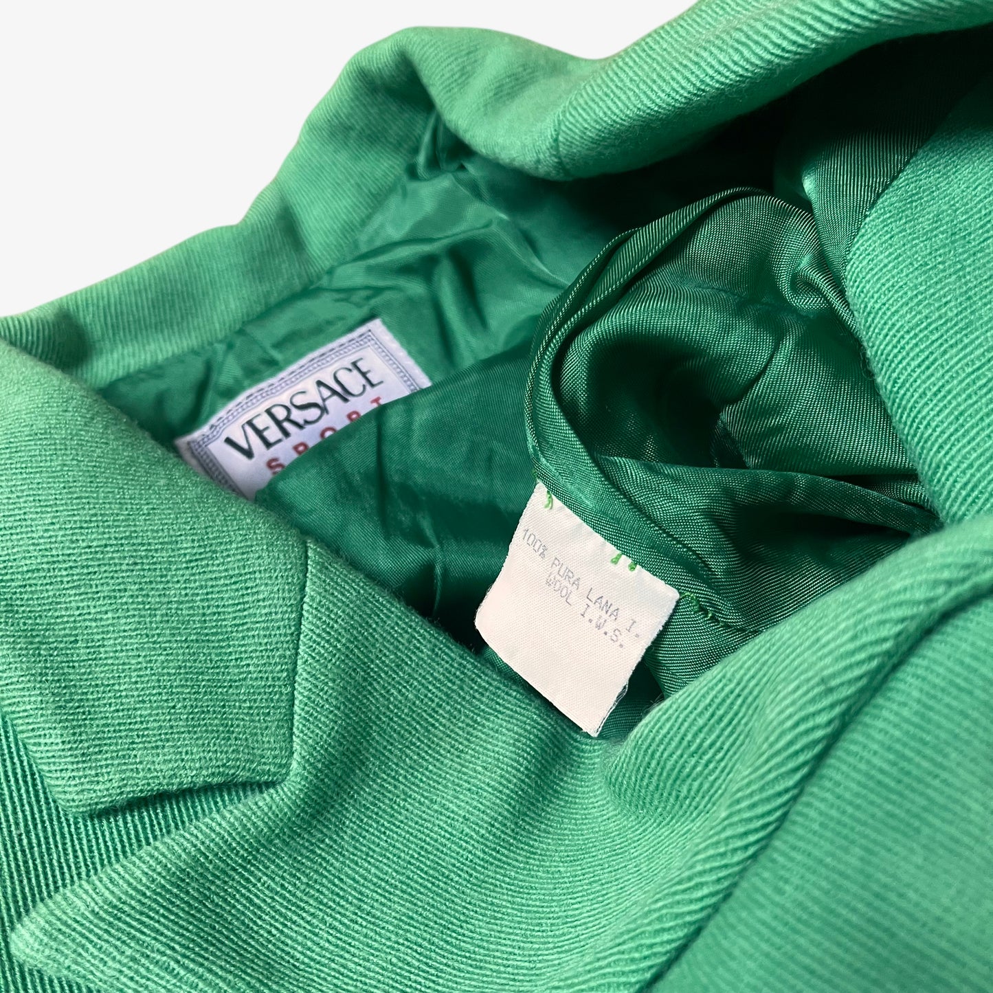 Inside label for vintage 70s Versace Sport women’s green wool blazer.