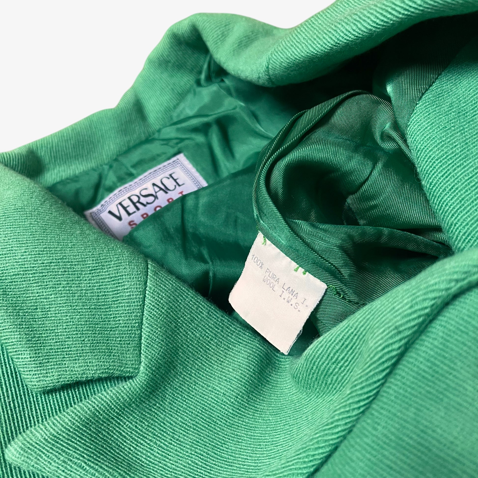Inside label for vintage 70s Versace Sport women’s green wool blazer.