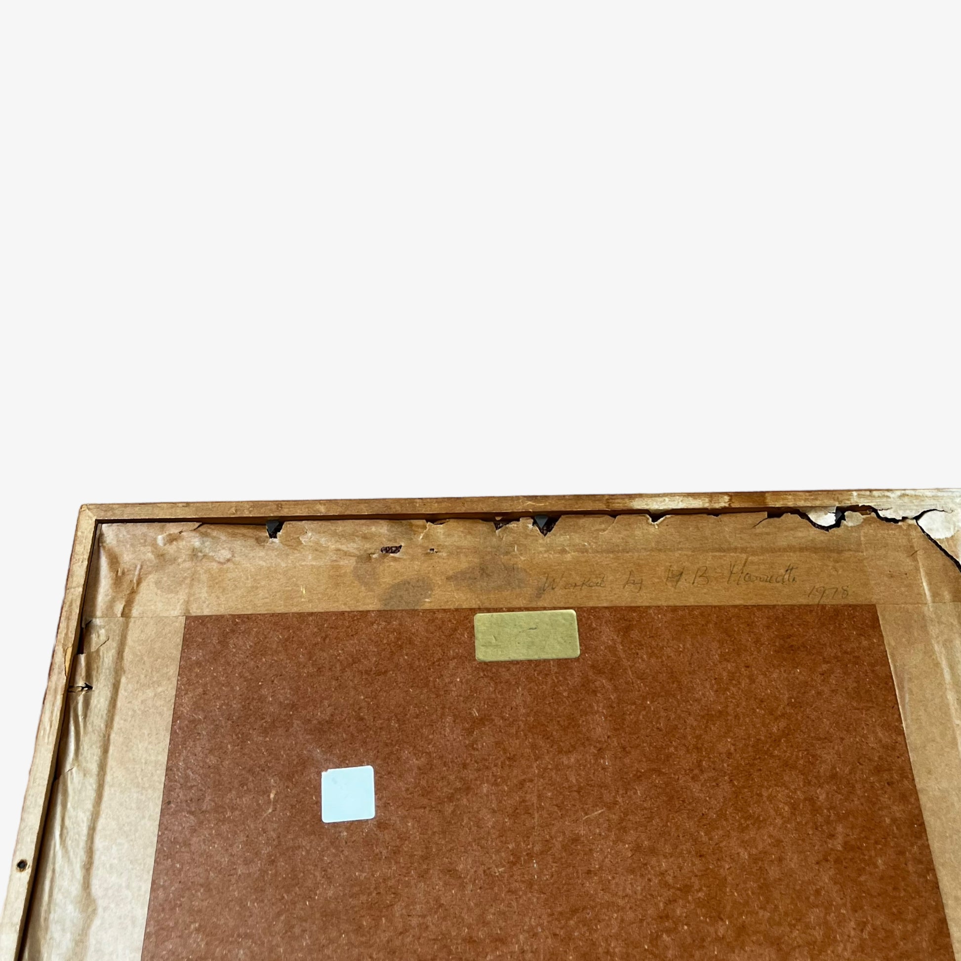 Wear on the back of wooden framed vintage 70s peacock cross stitch tapestry.