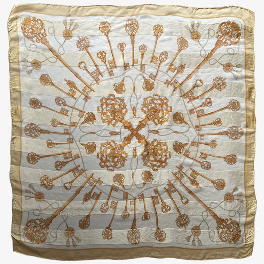 Women's vintage 80s Balenciaga Paris yellow silk scarf with a gold baroque style key print.