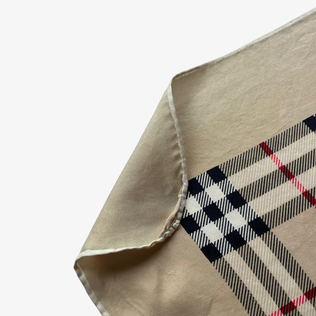 Hand rolled edges on women's vintage 80s Burberry London nova check print silk scarf.