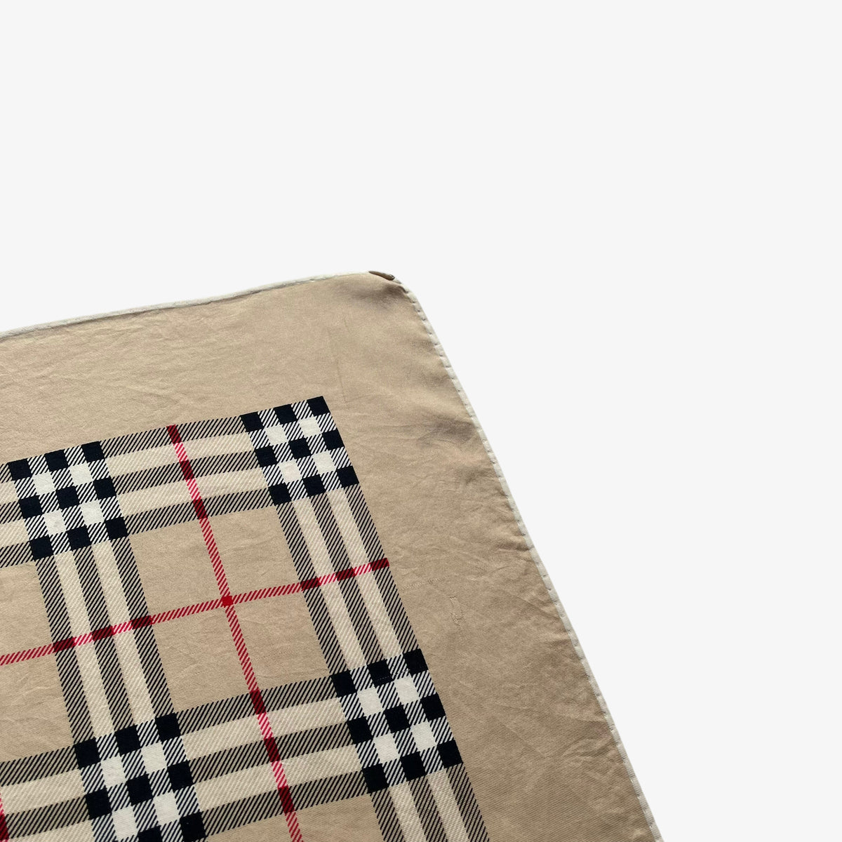 Hem of women's vintage 80s Burberry London nova check print silk scarf.