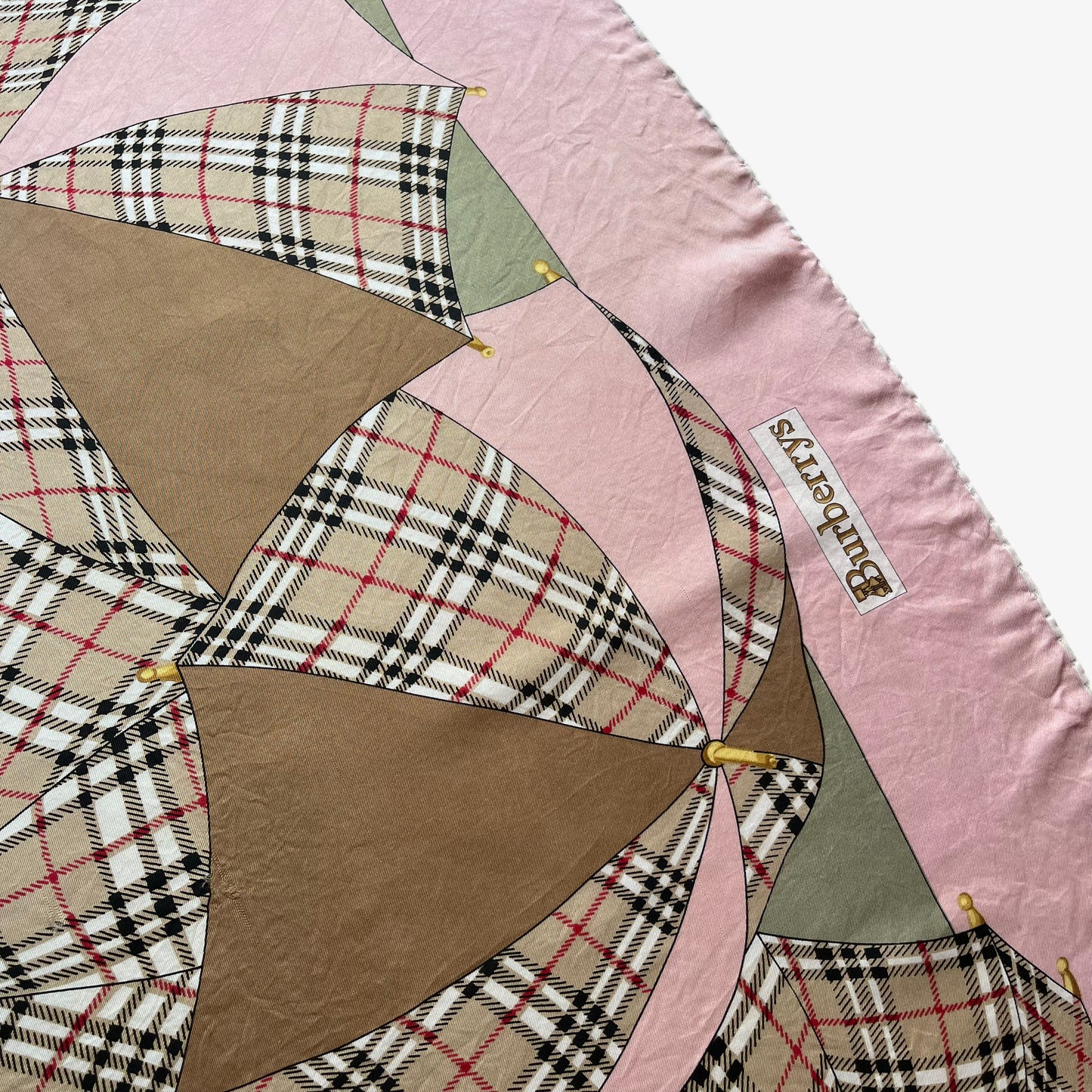 Hem of women's vintage 80s Burberry nova check umbrella print pink silk scarf.