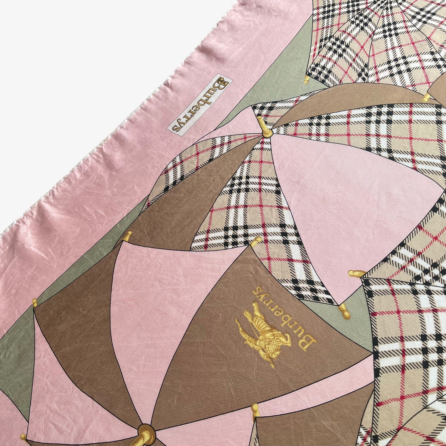 General wear on women's vintage 80s Burberry nova check umbrella print pink silk scarf.