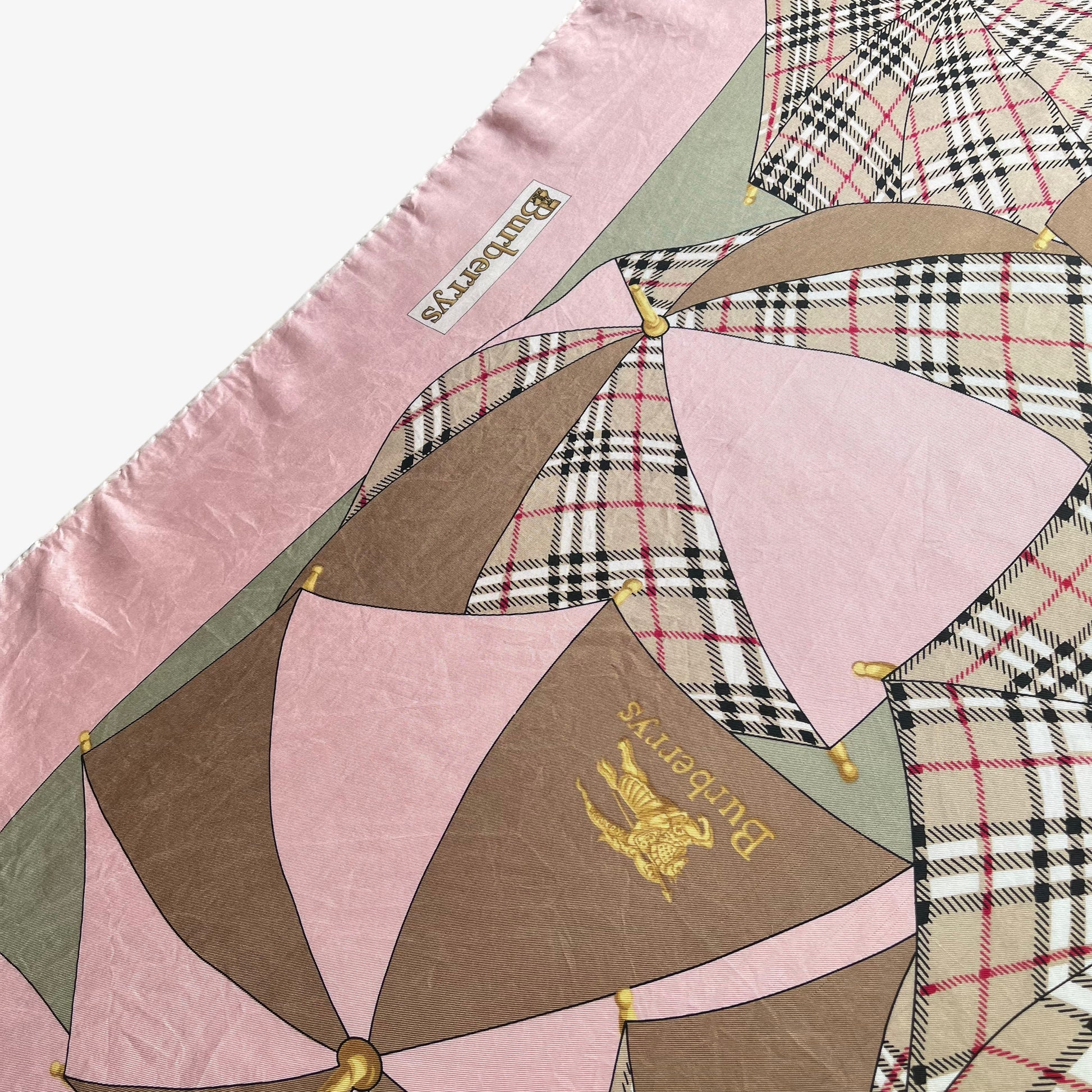 General wear on women's vintage 80s Burberry nova check umbrella print pink silk scarf.