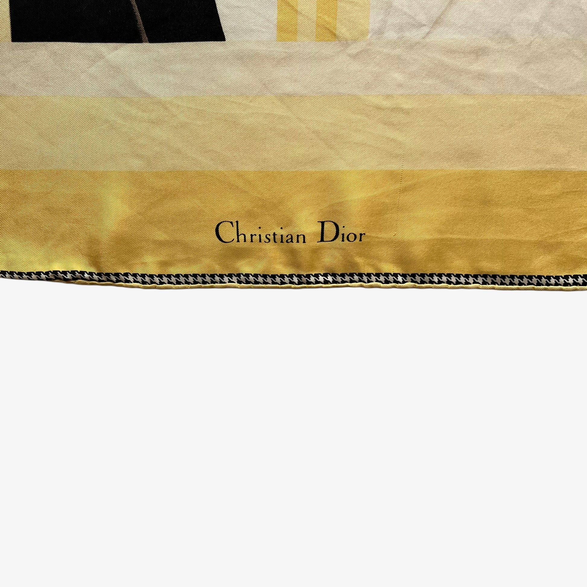 Christian Dior spell out logo on women's vintage 80s art deco wedding dress print yellow silk scarf with a black and white houndstooth trim.
