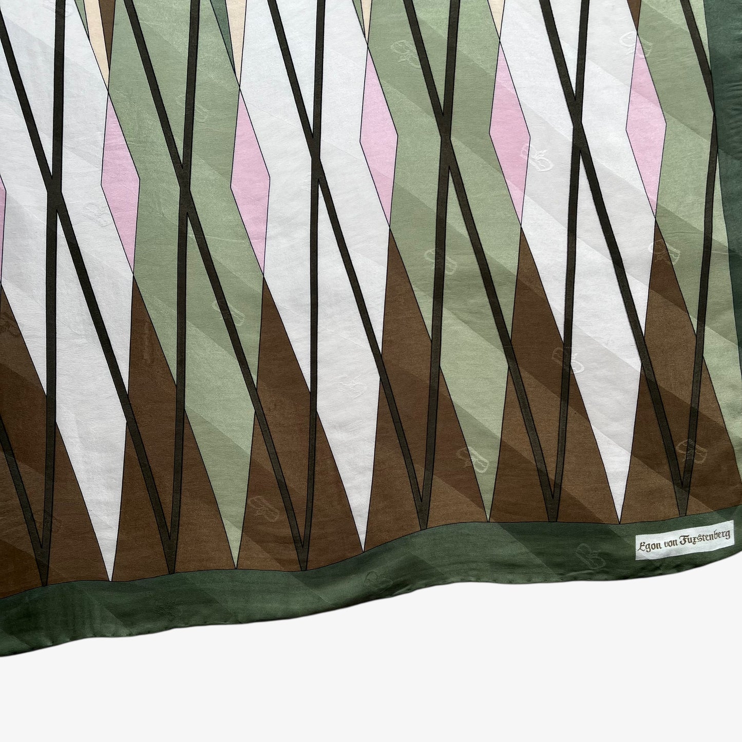 Close up of geometric abstract brown and pink tartan print of women's vintage 80s Egon Von Furstenberg green silk scarf.
