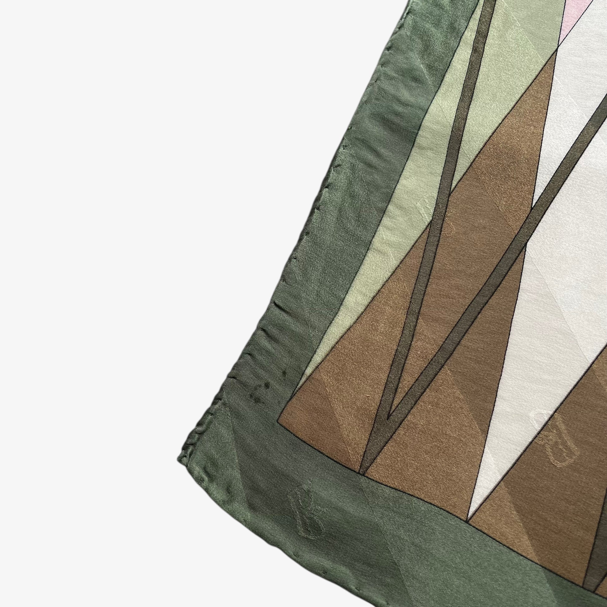 Hand rolled edges of women's vintage 80s Egon Von Furstenberg abstract brown and pink tartan print green silk scarf.