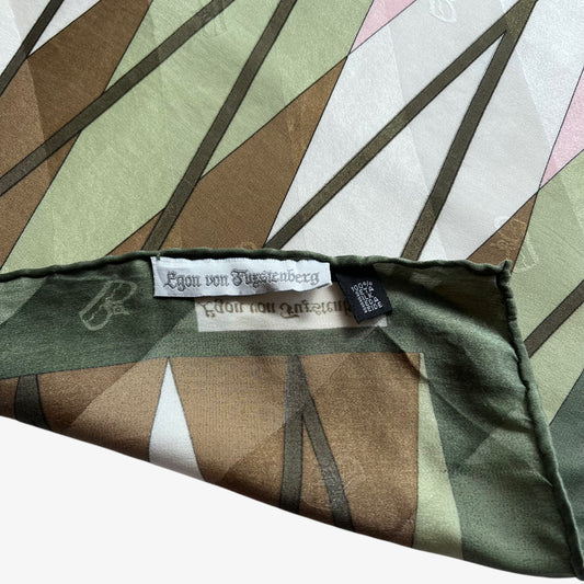 Label and hand rolled edges of women's vintage 80s Egon Von Furstenberg abstract tartan print green silk scarf.