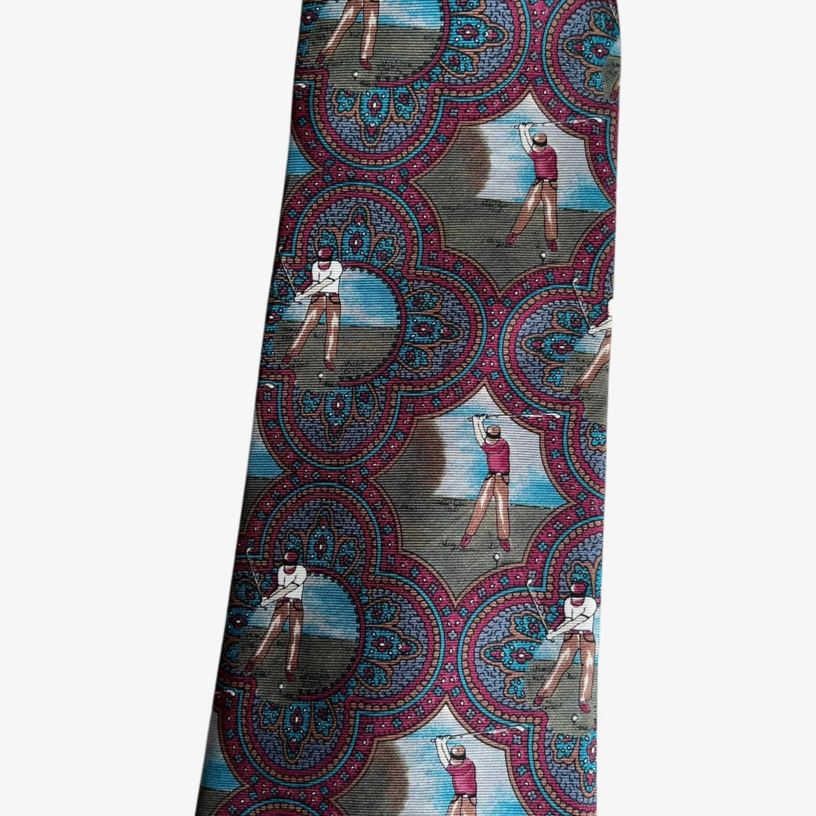 Close up of vintage 80s Europeennes purple silk tie with geometric paisley and golf print design.