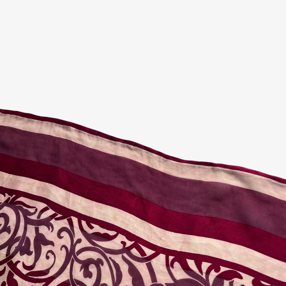 Hand rolled edges on women's 80s vintage Givenchy Foulards red silk scarf with abstract floral print.