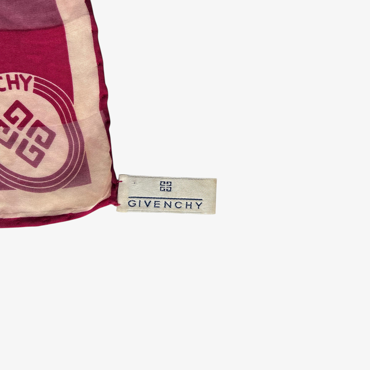 Givenchy label on women's 80s vintage red silk scarf with abstract floral print.