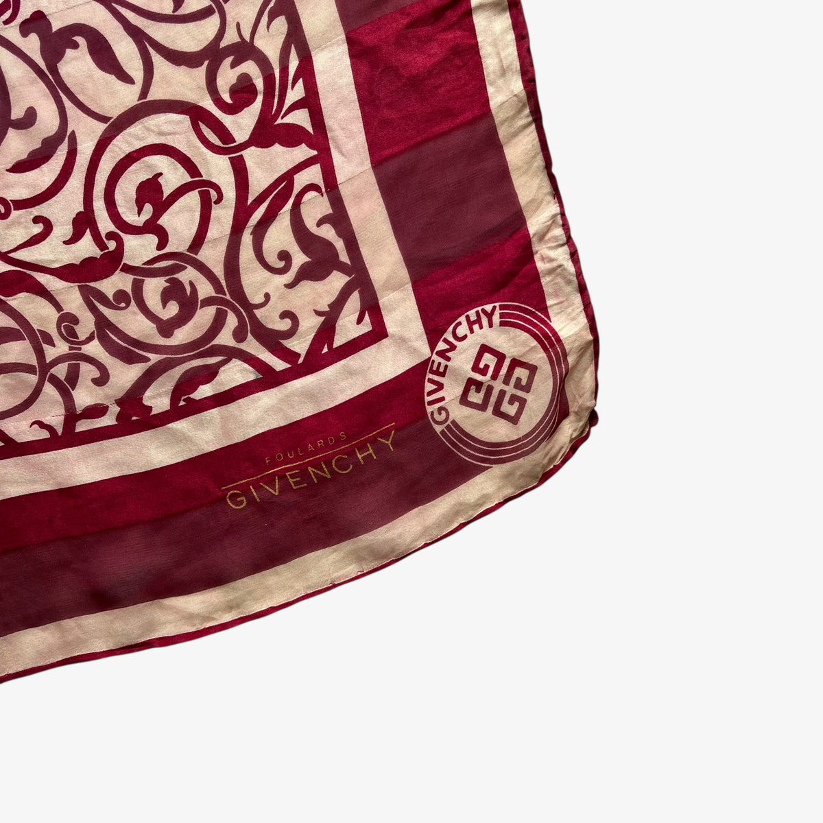 Givenchy foulards logo on women's 80s vintage red silk scarf with abstract floral print.