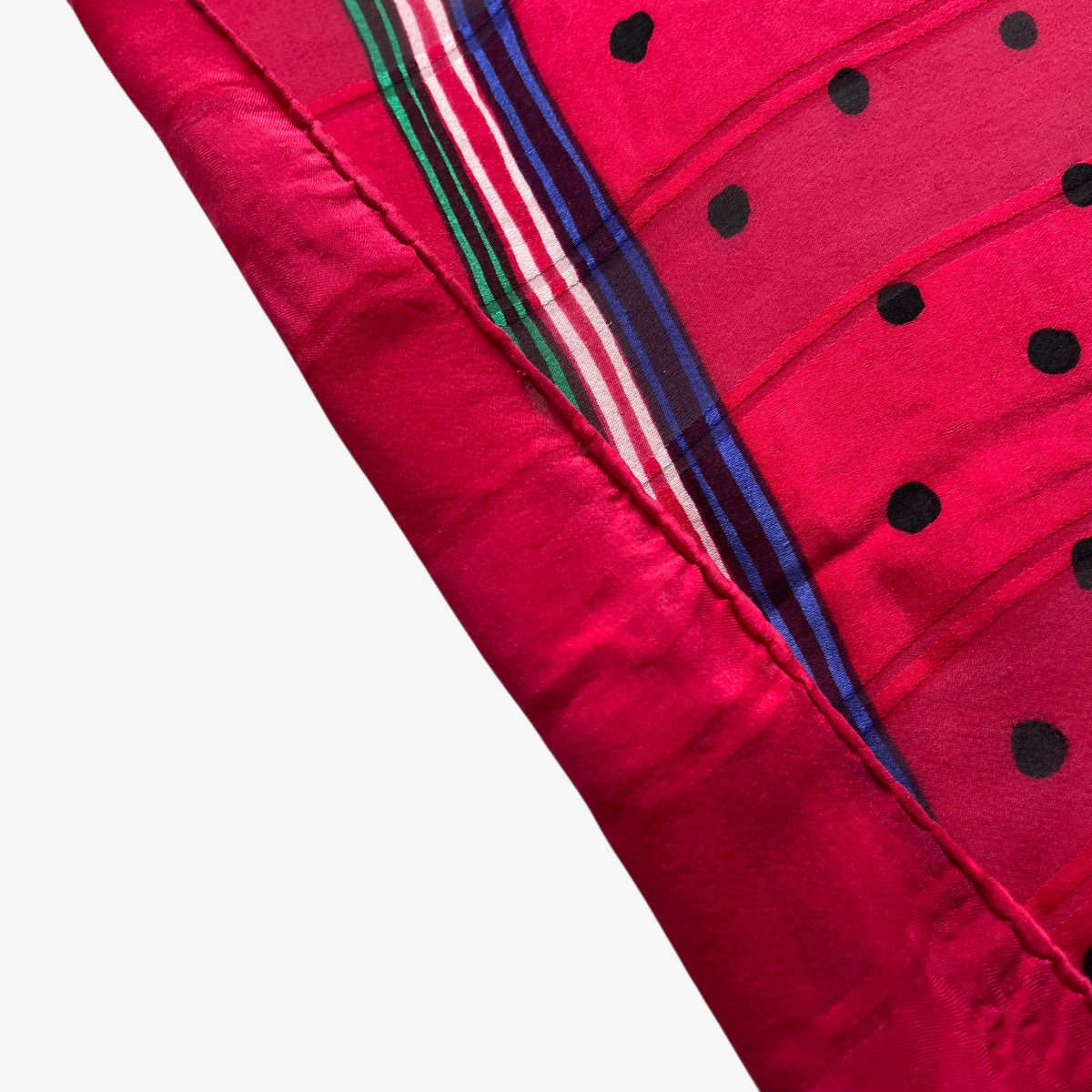 Elegant hand rolled edge of vintage 80s Givenchy red silk scarf which features a polka dot print.