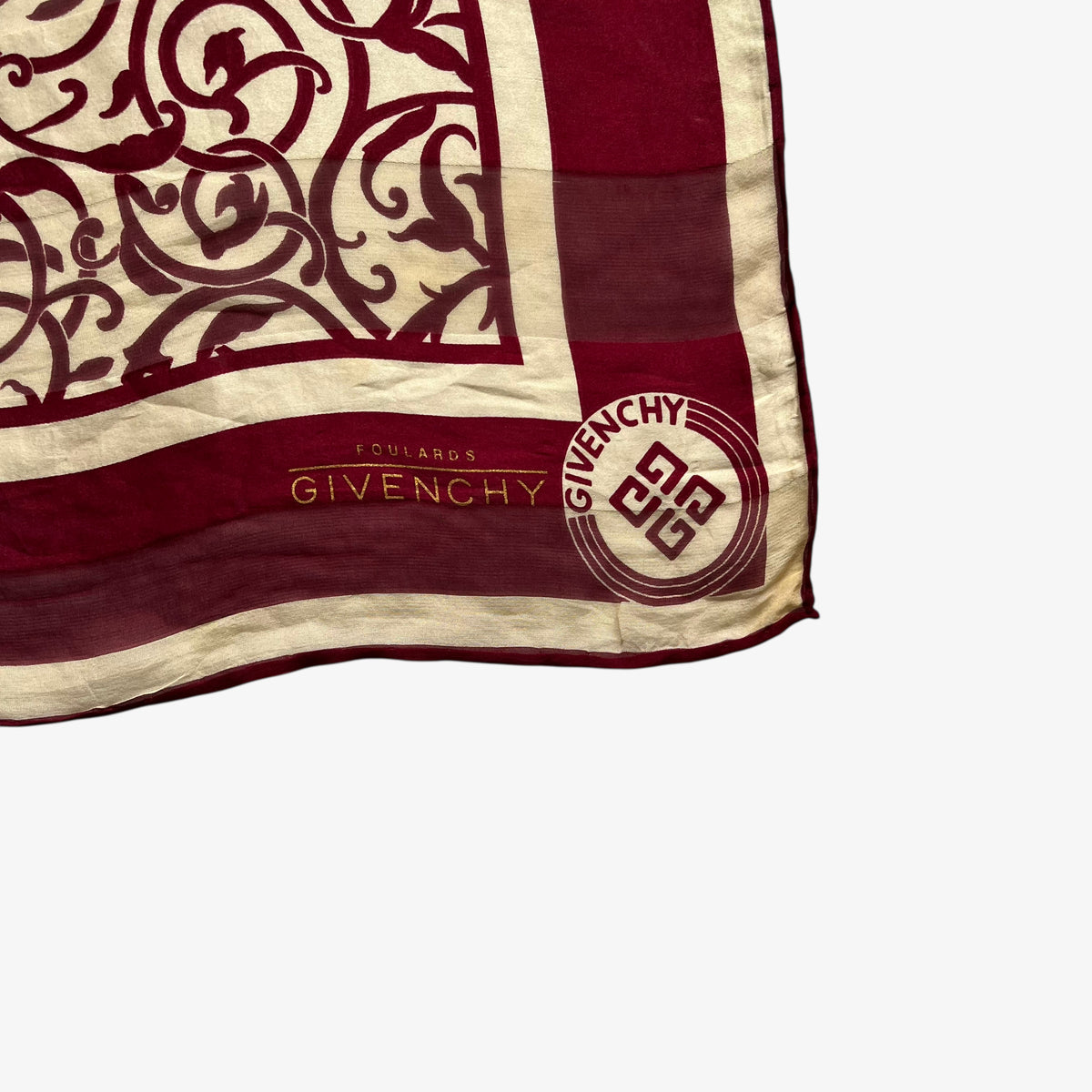 Givenchy foulards logo on a red silk scarf with an abstract floral print.