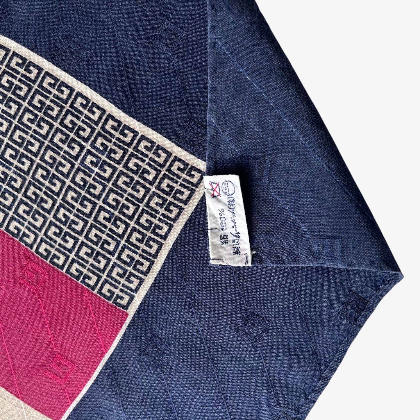 Label of navy and red striped Givenchy vintage 80s silk scarf with G monogram print.