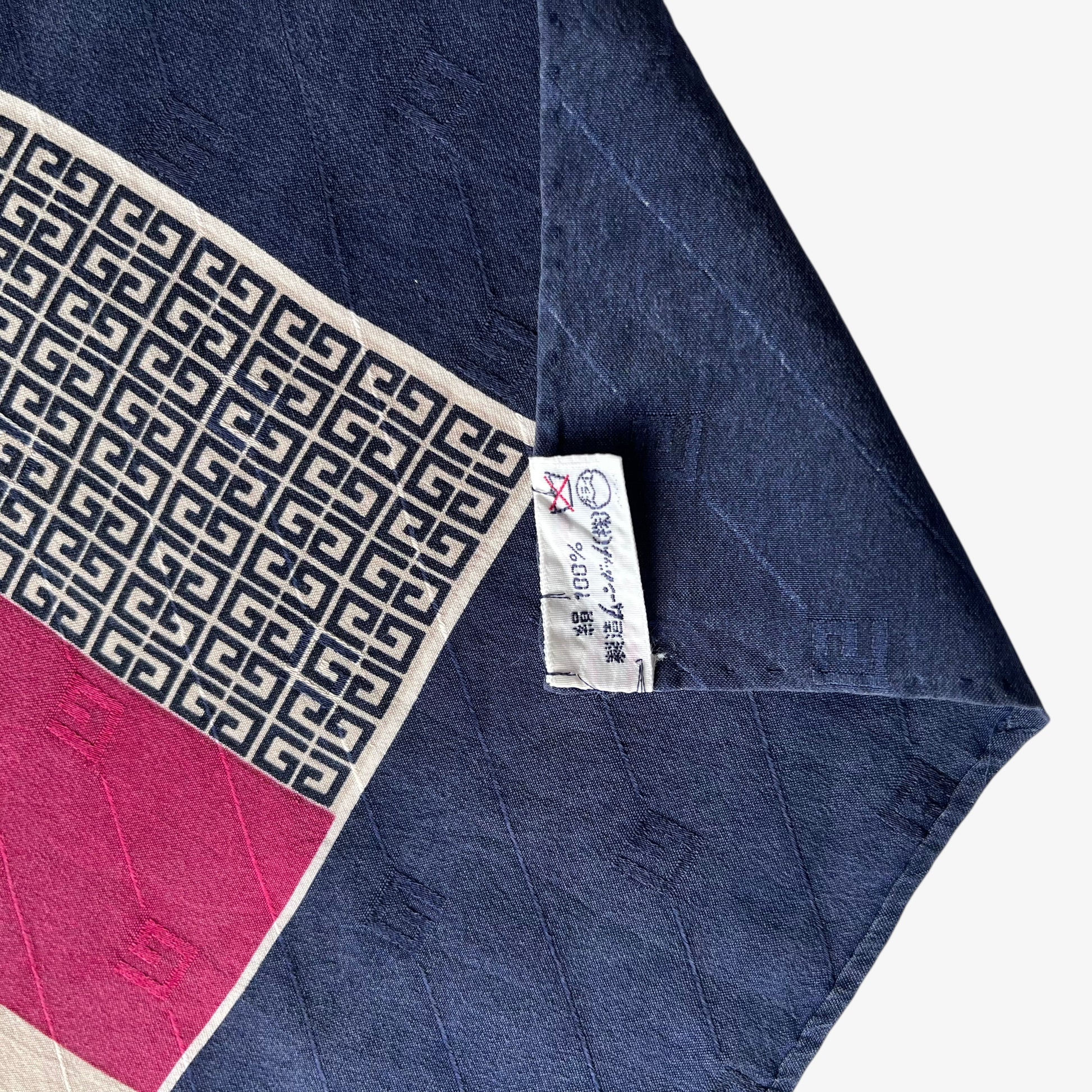 Label of navy and red striped Givenchy vintage 80s silk scarf with G monogram print.