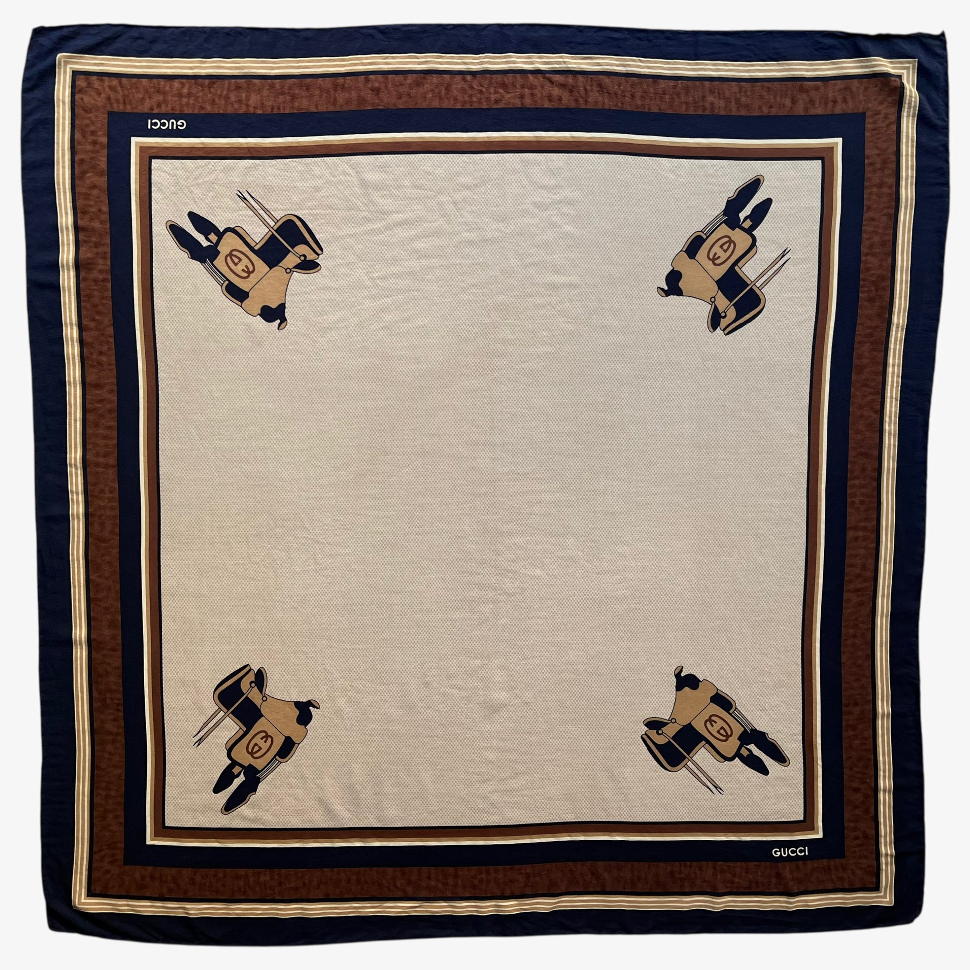 Women's vintage 80s Gucci equestrian saddle print brown silk scarf features a GG interlocking pattern.