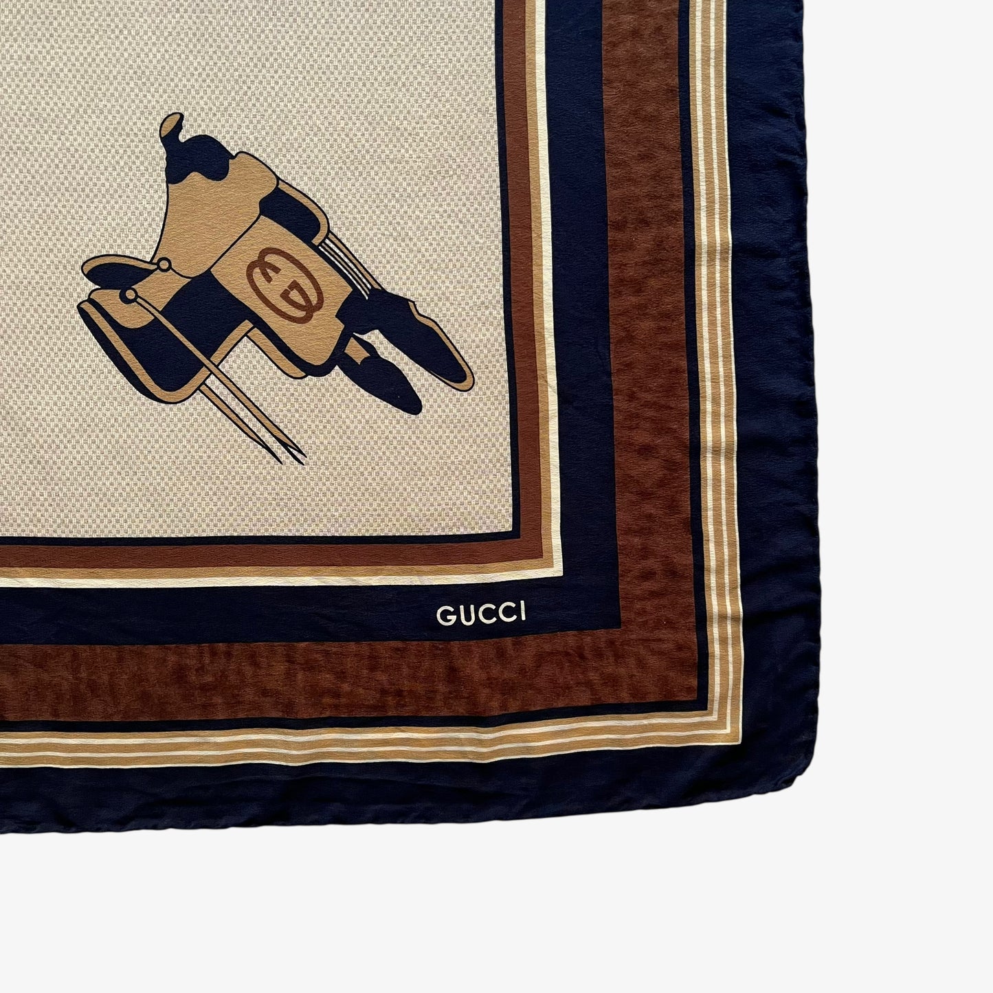 Gucci logo of women's vintage 80s equestrian saddle print brown silk scarf features a GG interlocking pattern.