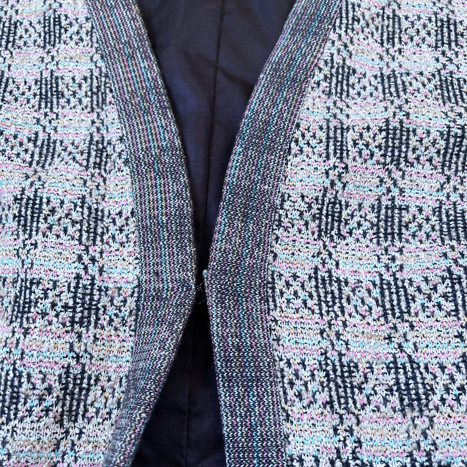 Hook and eye fastening of vintage 80s men's colourful checkered patterned wool blend waistcoat.