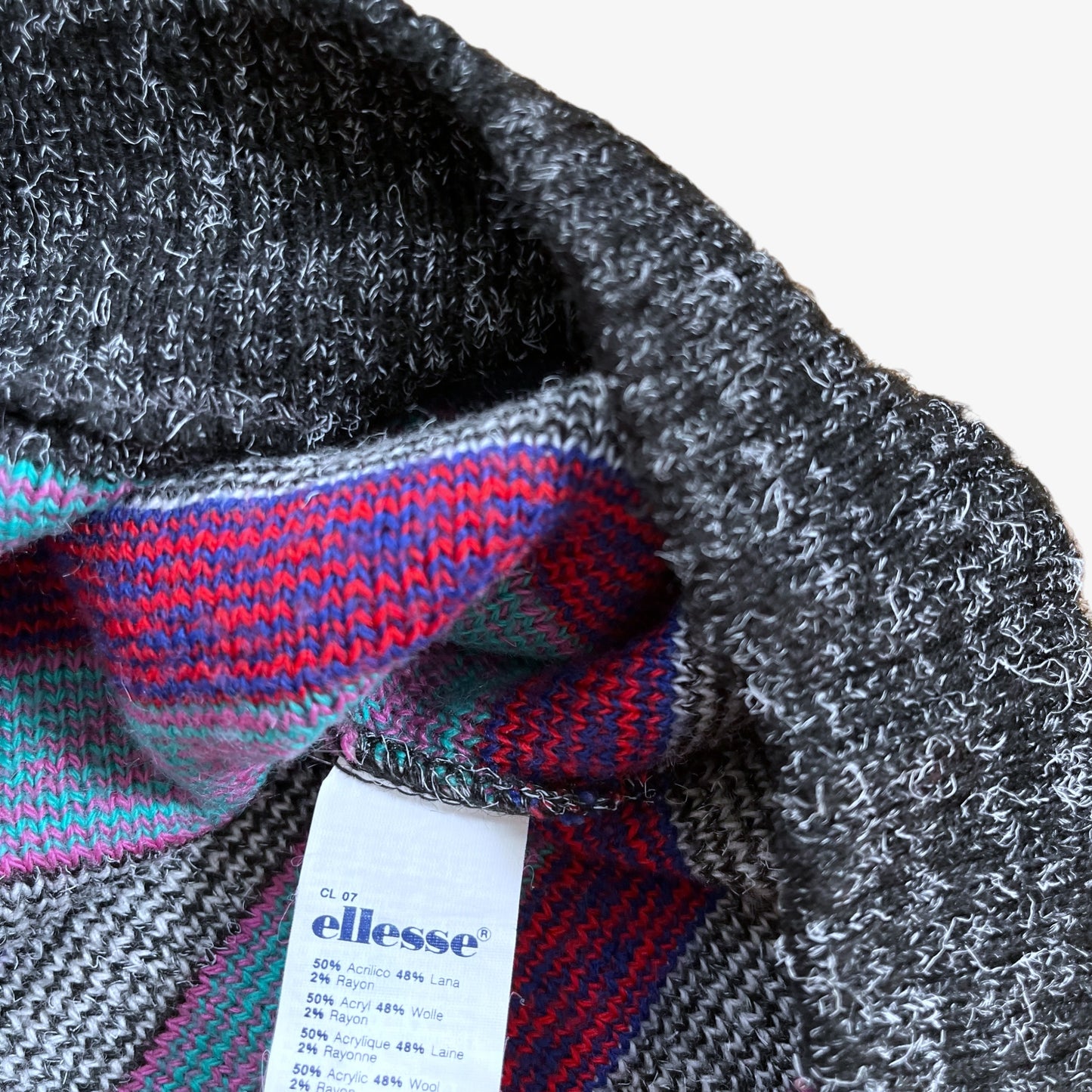 Close up of a material label inside of a colourful pattern sweater.