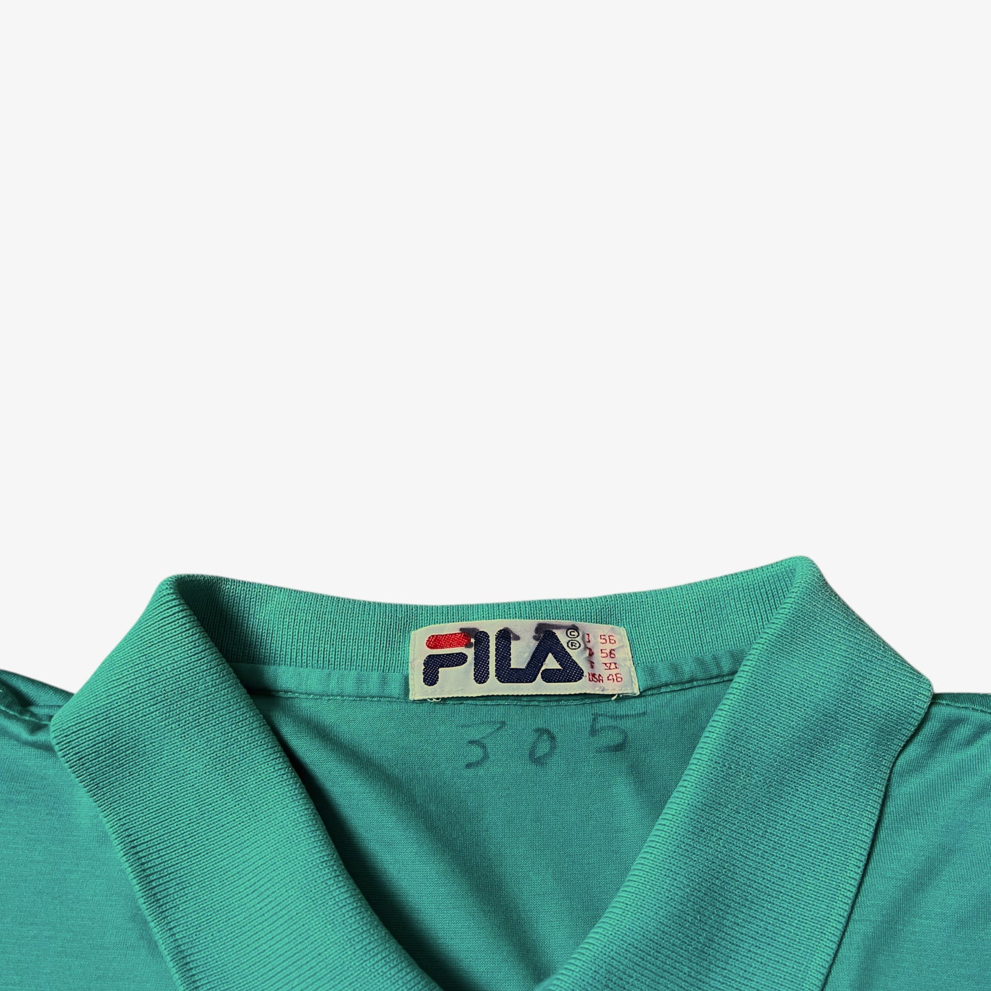 Vintage 80s Fila label stitched inside of a green polo shirt.