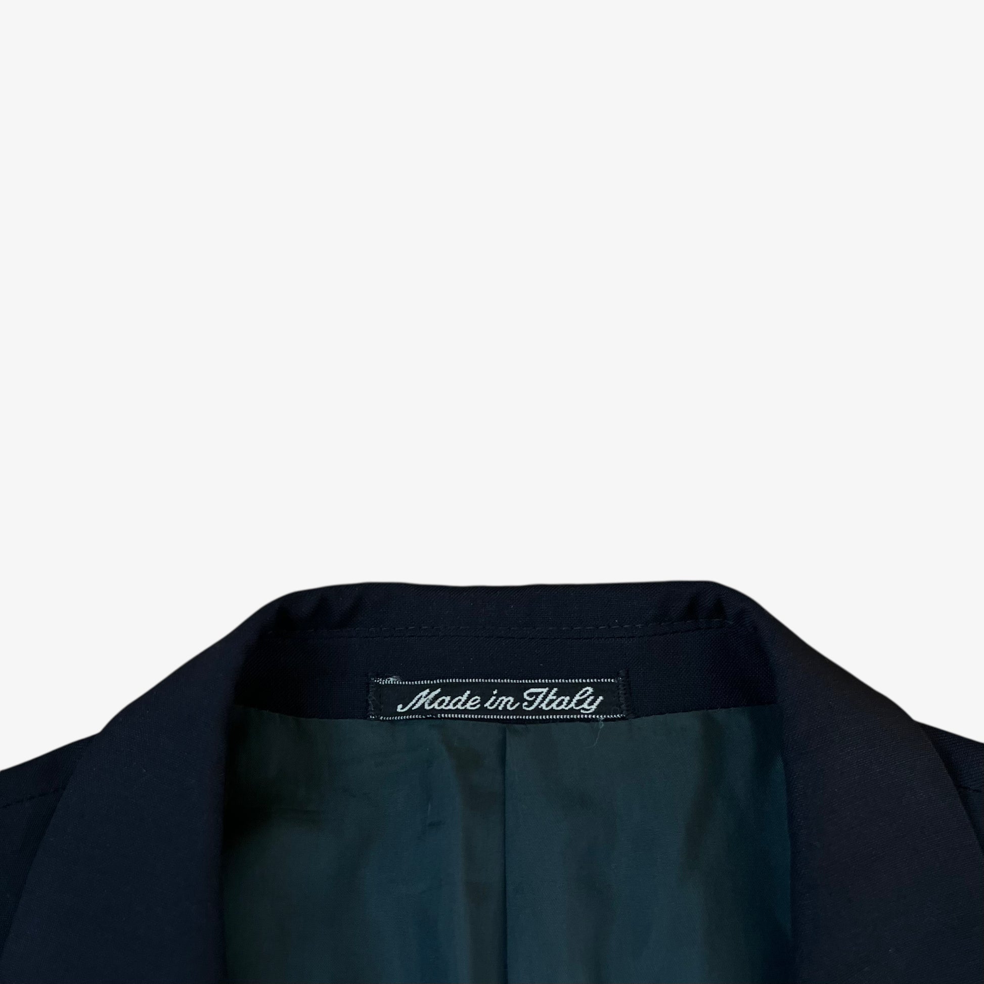 Made in Italy label stitched inside of men's vintage 80s Giorgio Armani Le Collezioni navy double breasted wool blazer.