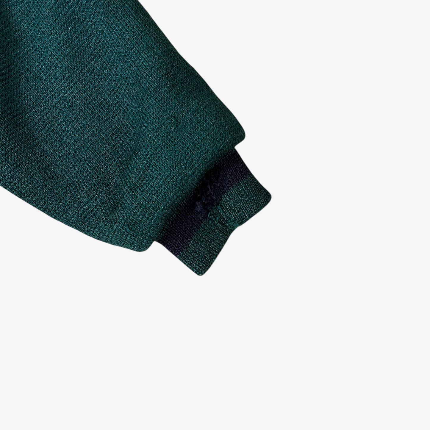 Sleeve of vintage 80s Looney Tunes ICEBERG men’s green and navy wool varsity jacket.