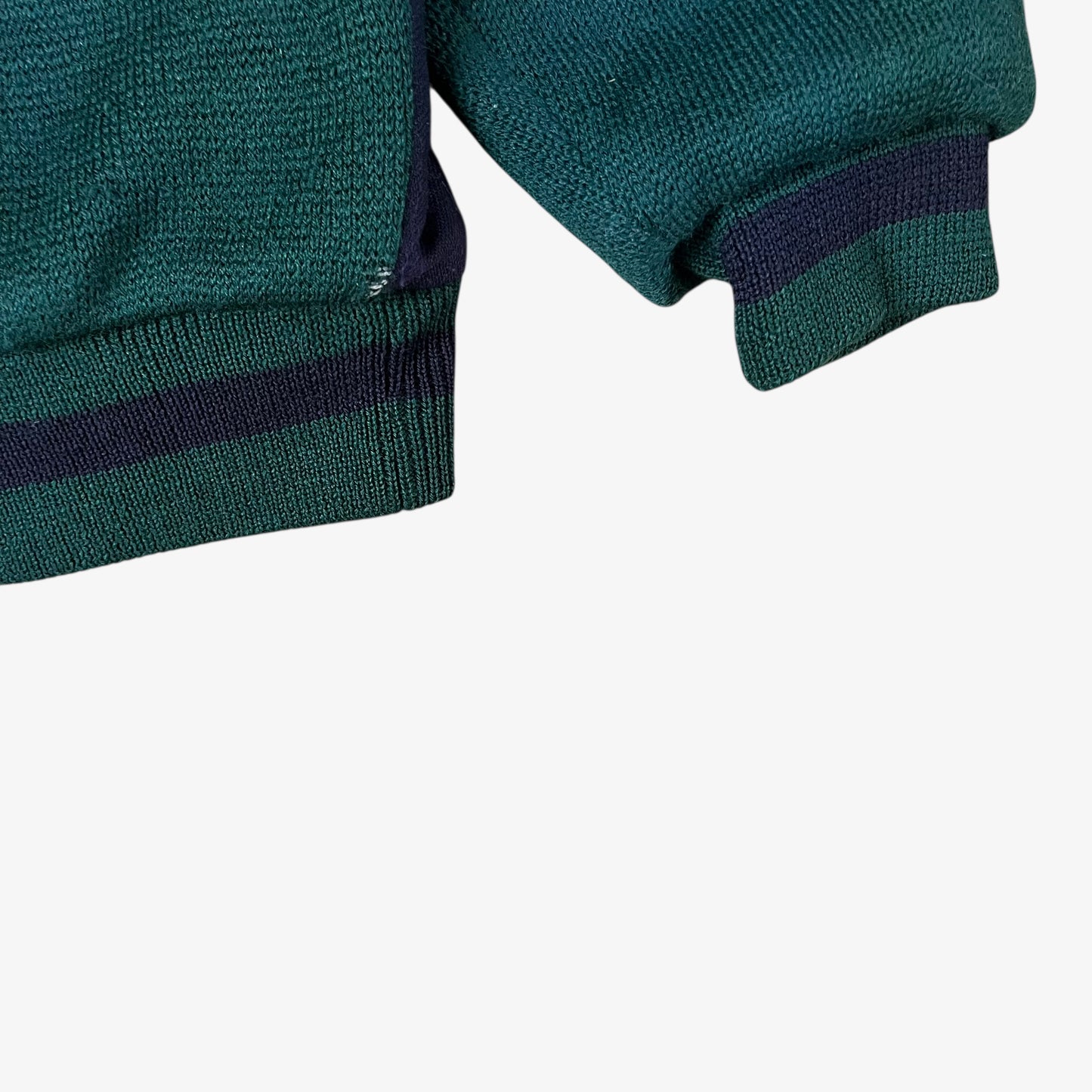 Hem of vintage 80s Looney Tunes ICEBERG men’s green and navy wool varsity jacket.