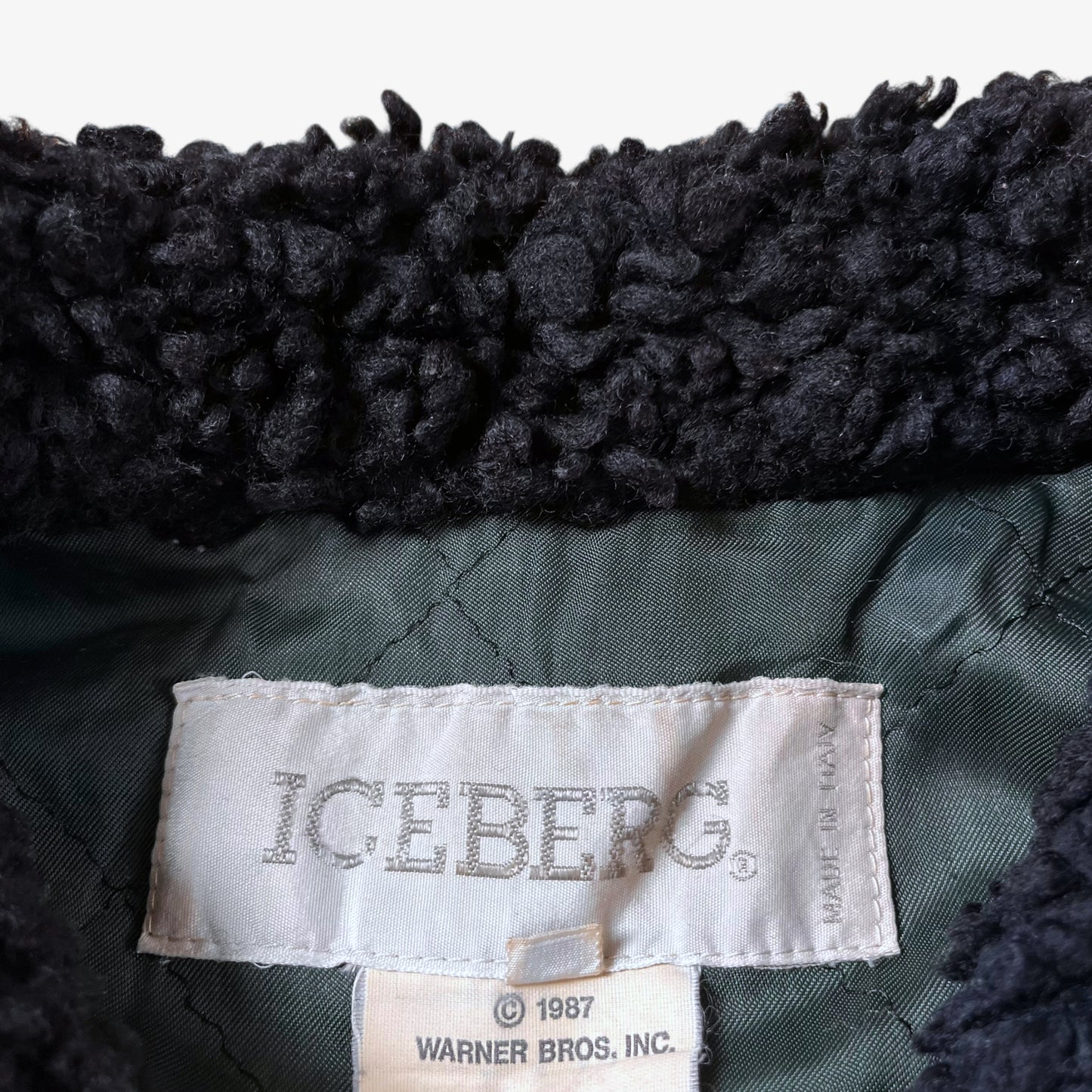 Label of vintage 80s Looney Tunes ICEBERG men’s green and navy wool varsity jacket.