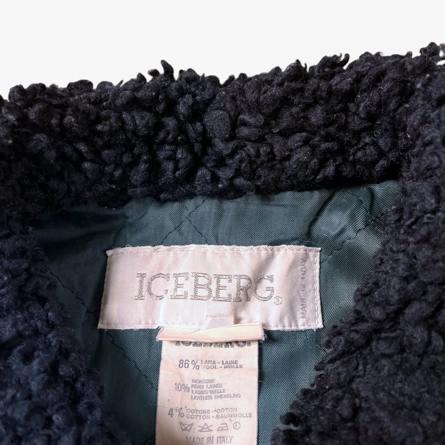 Material label of vintage 80s Looney Tunes ICEBERG men’s green and navy wool varsity jacket.