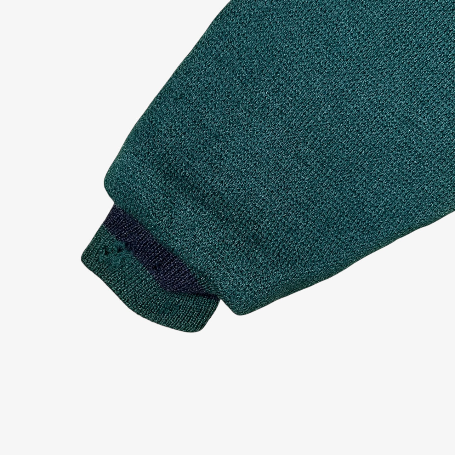 Cuff of vintage 80s Looney Tunes ICEBERG men’s green and navy wool varsity jacket.