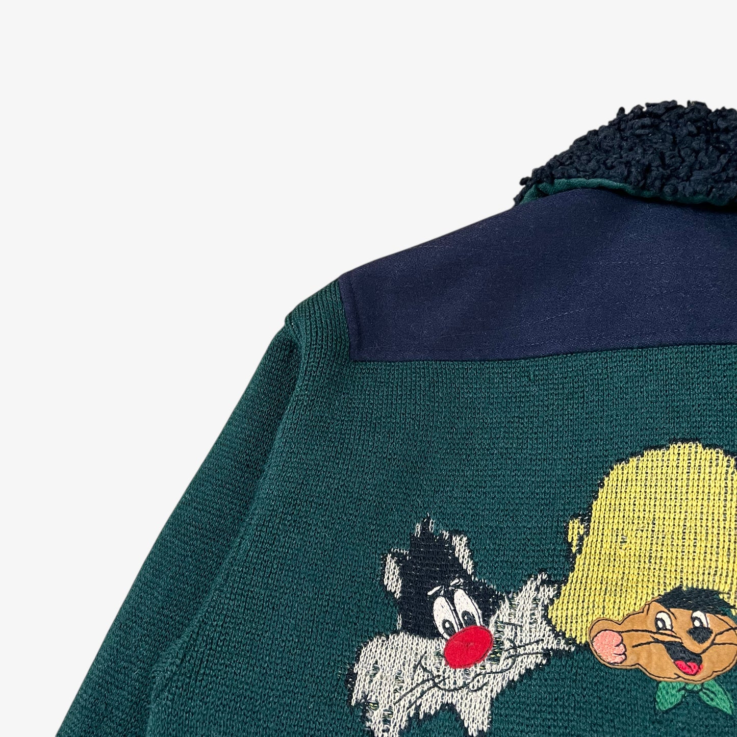Close up of cartoon detailing on vintage 80s Looney Tunes ICEBERG men’s green and navy wool varsity jacket.