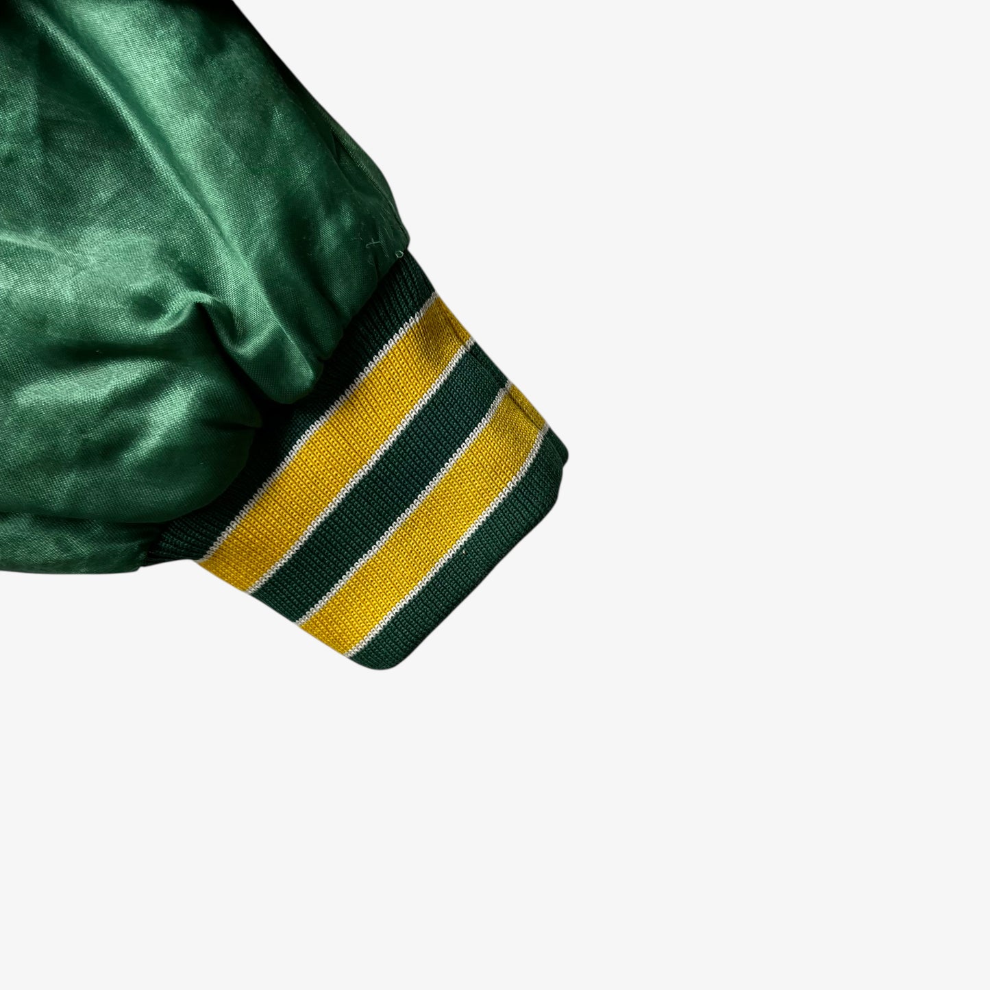 Cuff of vintage 80s men's Swingster MLB Oakland Athletics green varsity jacket.