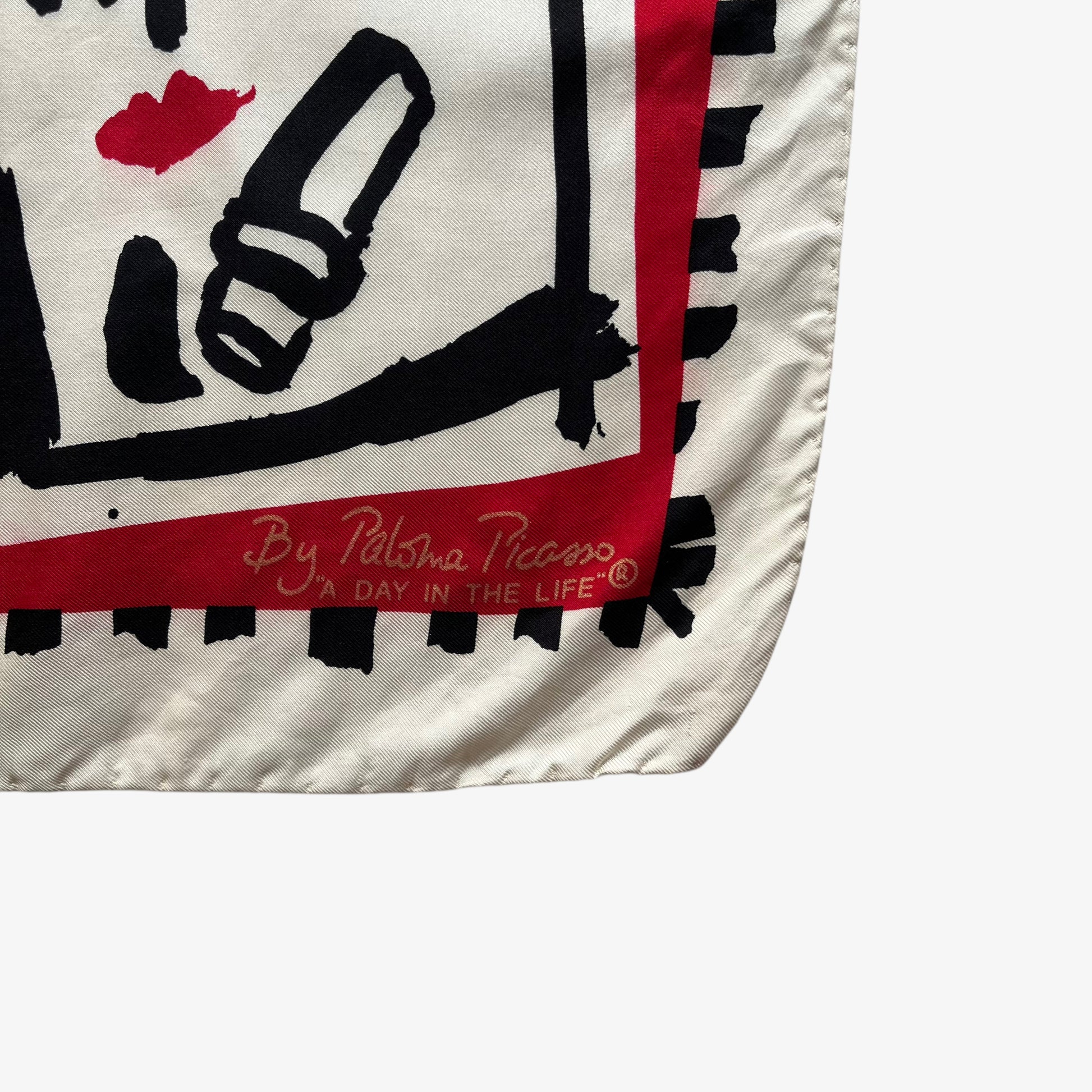 Paloma Picasso spell out logo on women's vintage 80s red silk scarf featuring the famous a day in the life of a woman design.